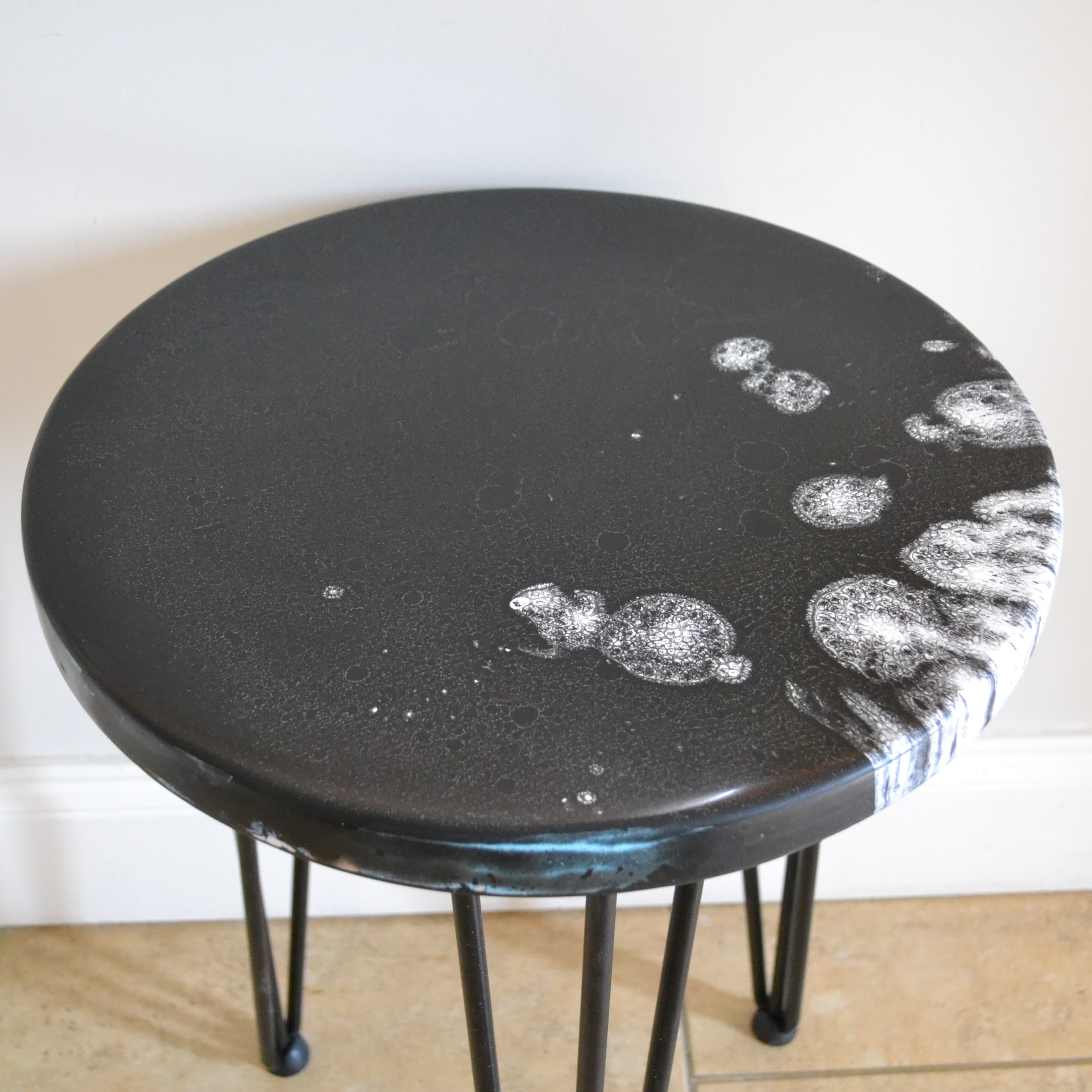 Overhead view of the black and white resin table surface.