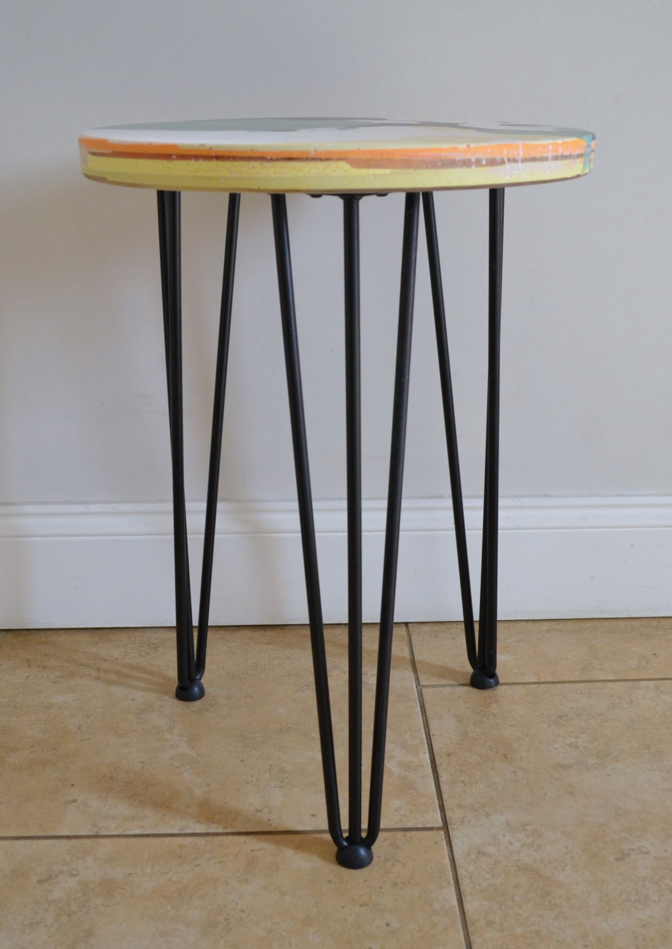 Green and black round side table made from workshop offcuts.