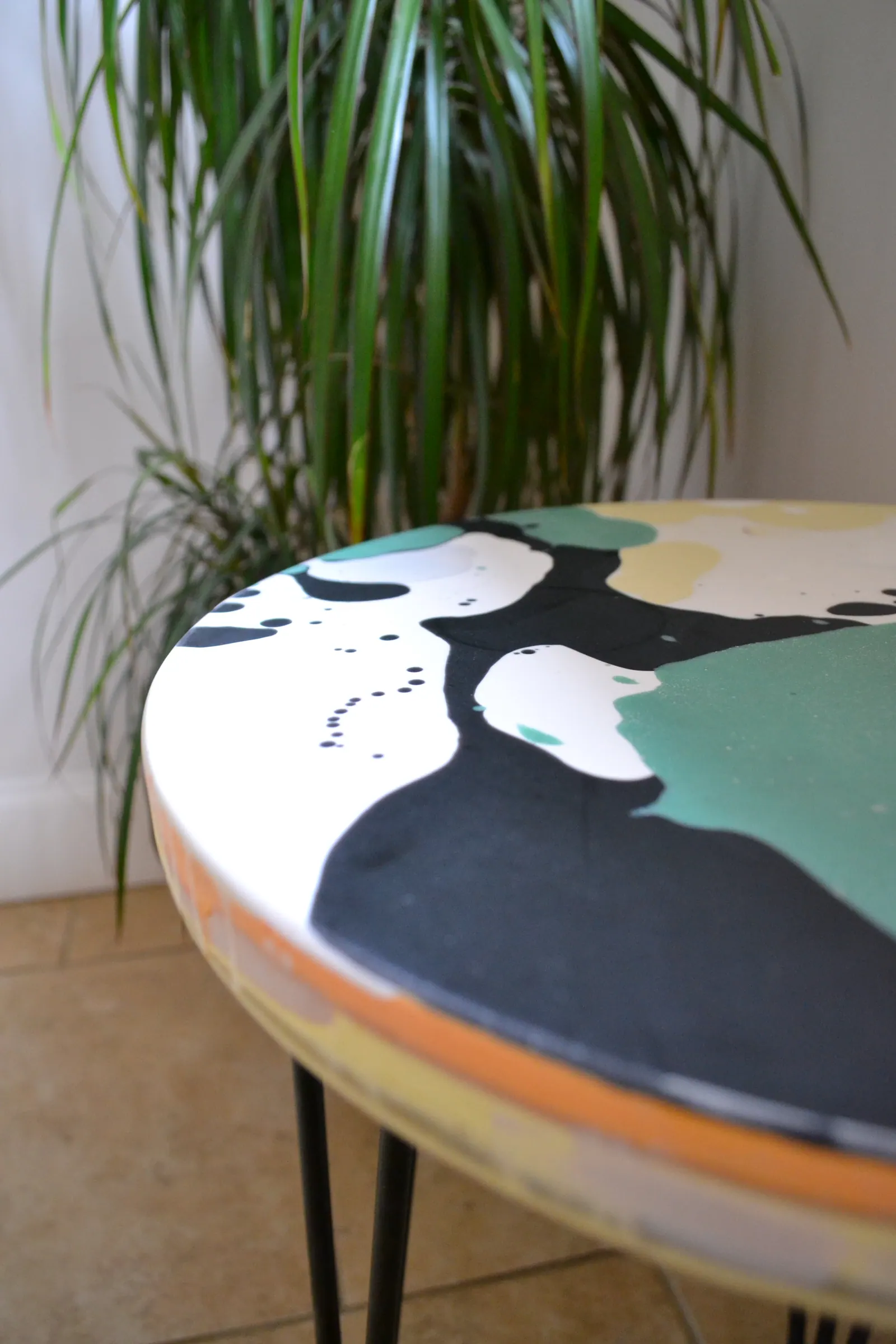 Close-up of resin and fibreglass texture on a green round table.