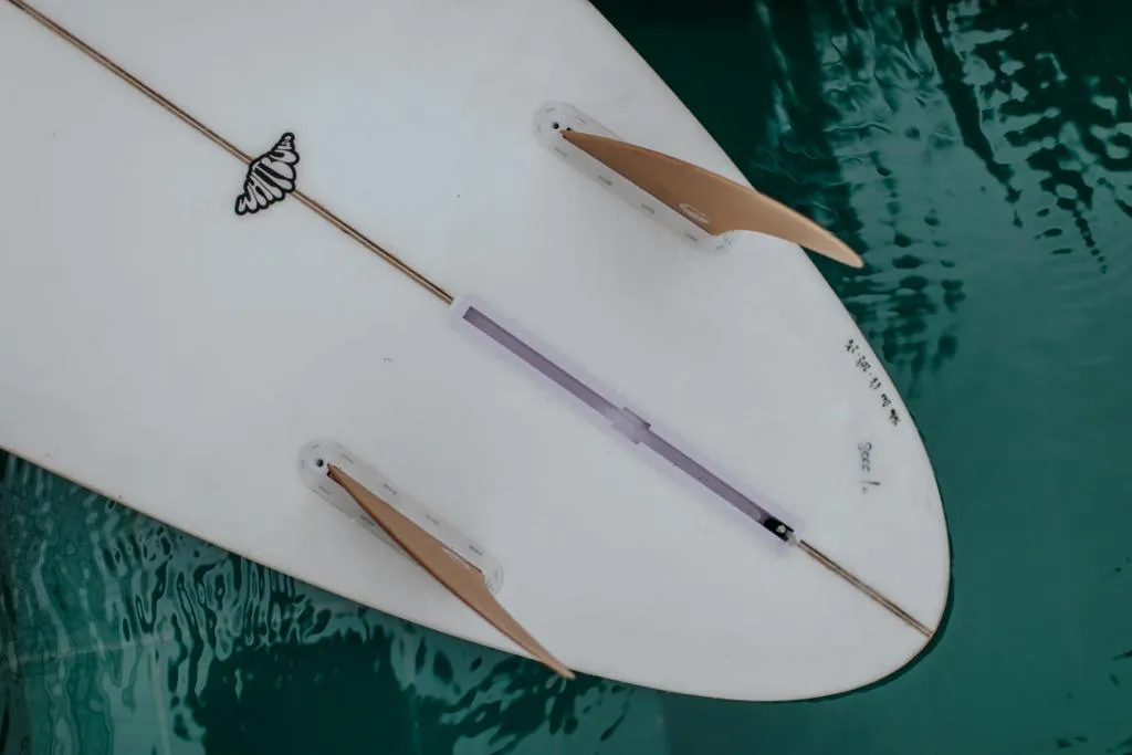 Whitburn surfboard logo visible in the water.