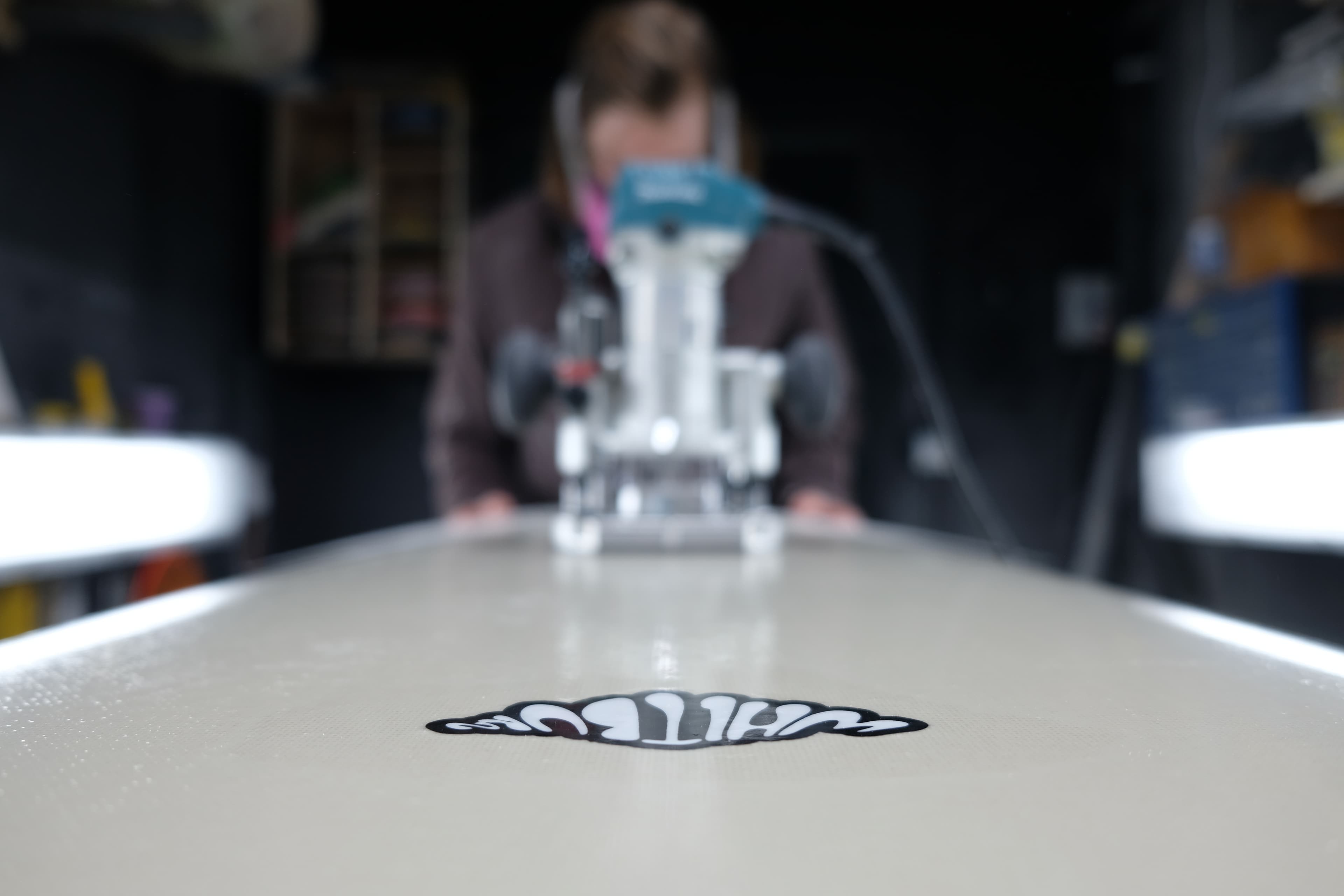 A Whitburn surfboard nose with the workshop logo in view.