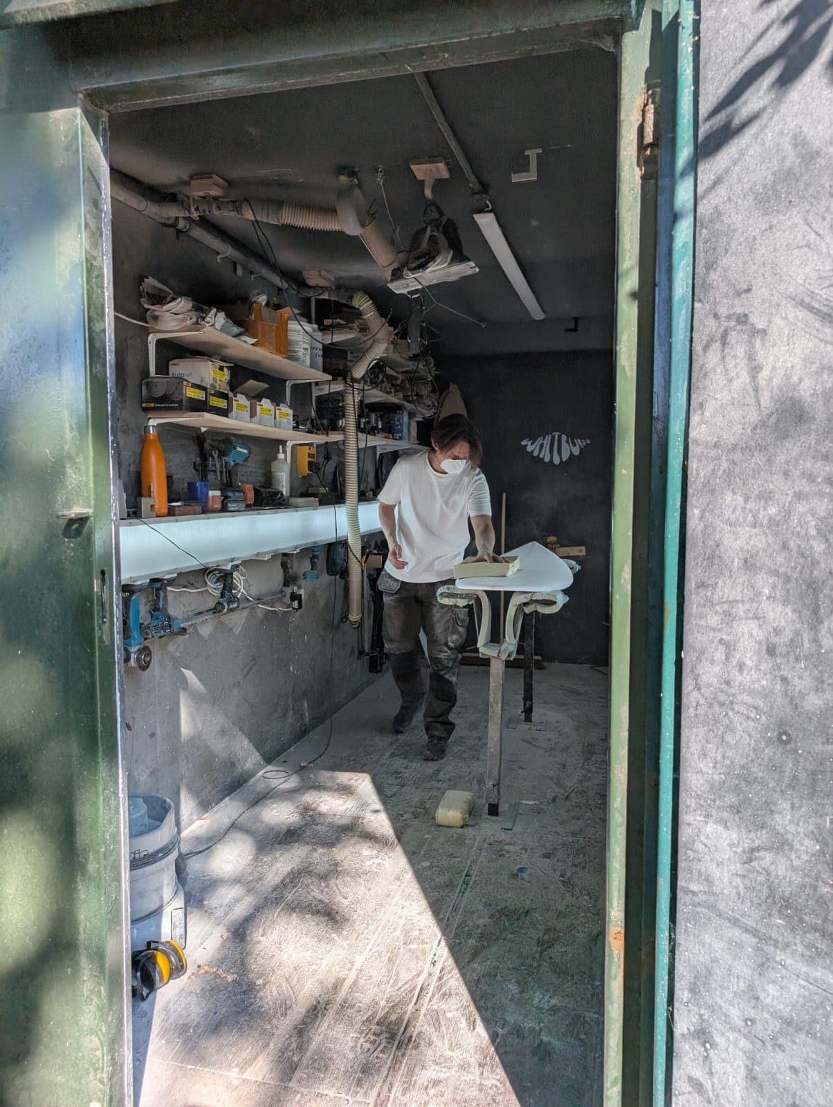 The Whitburn Studio shaping bay with a board on the stand.