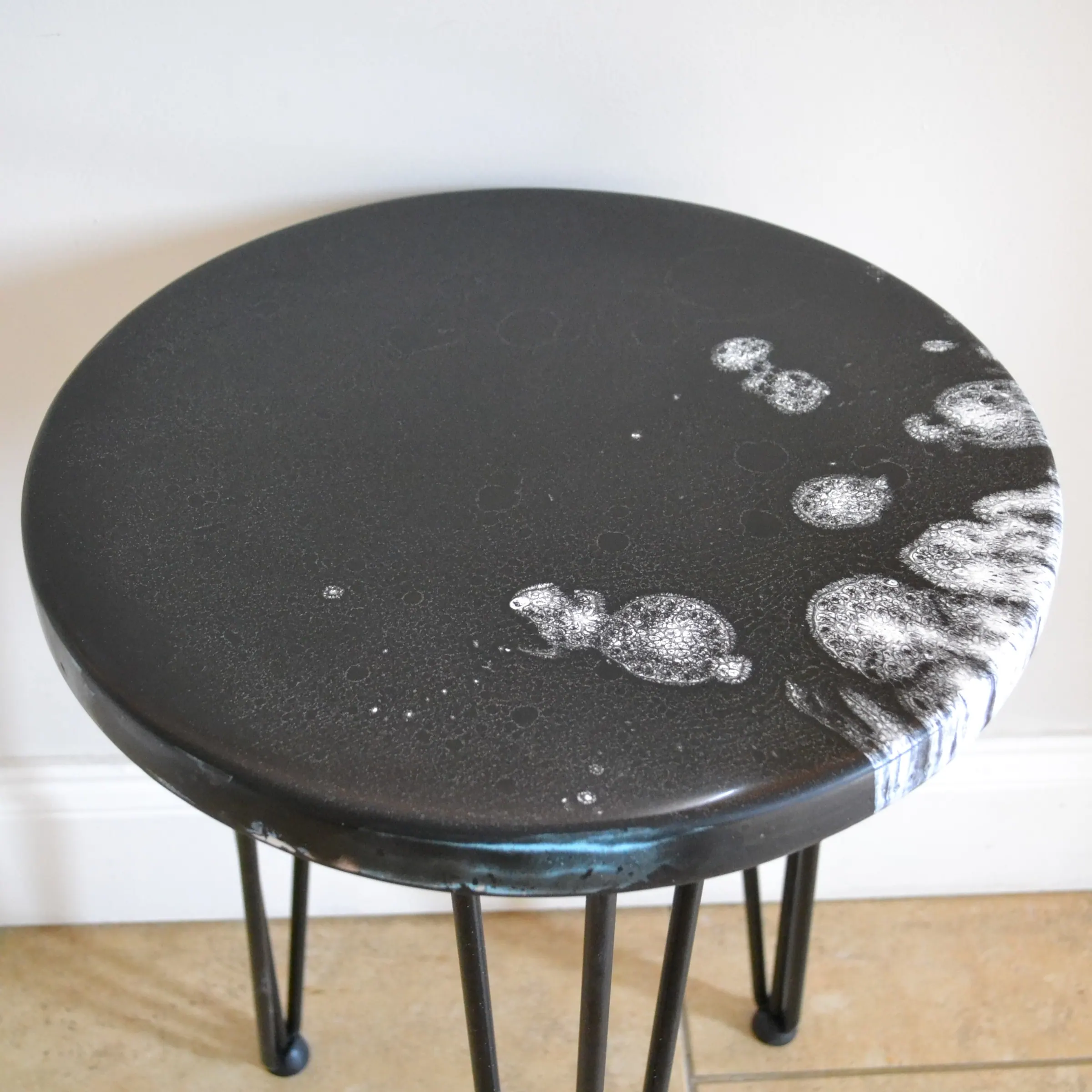Overhead view of the black and white resin table surface.
