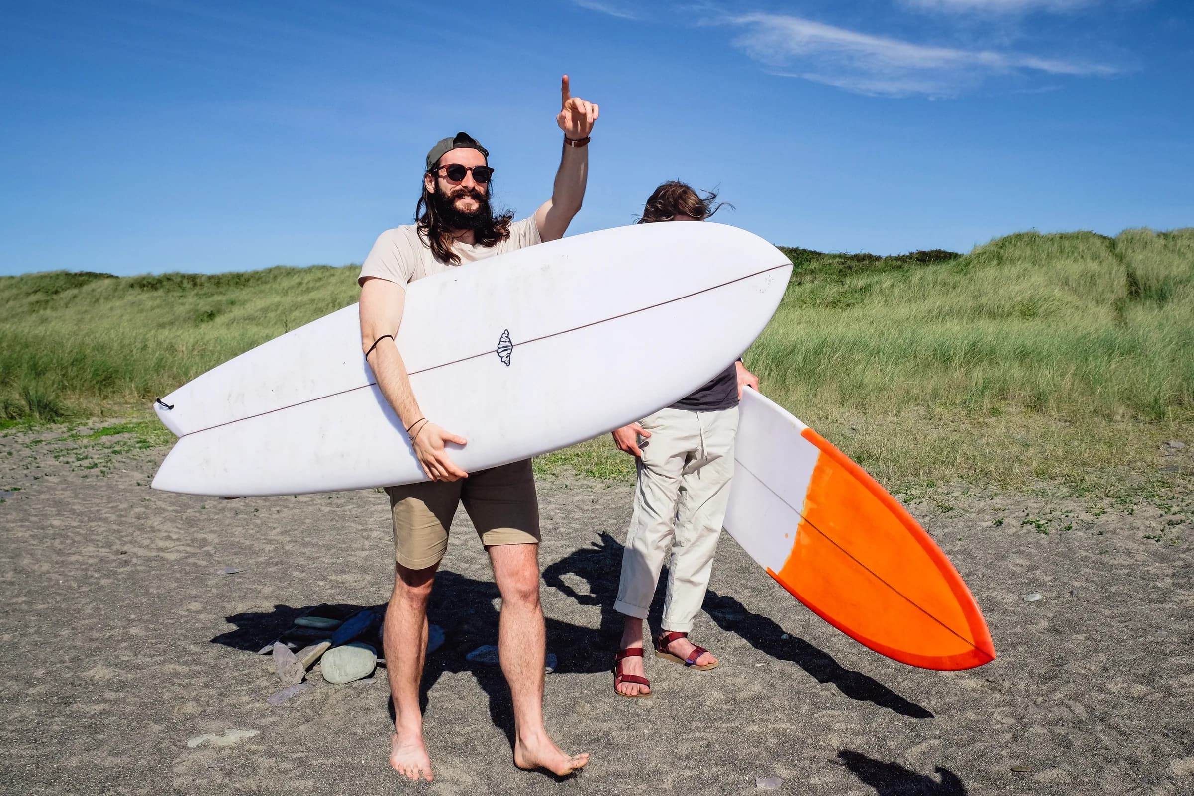 A Whitburn surfboard being held in coastal surf.