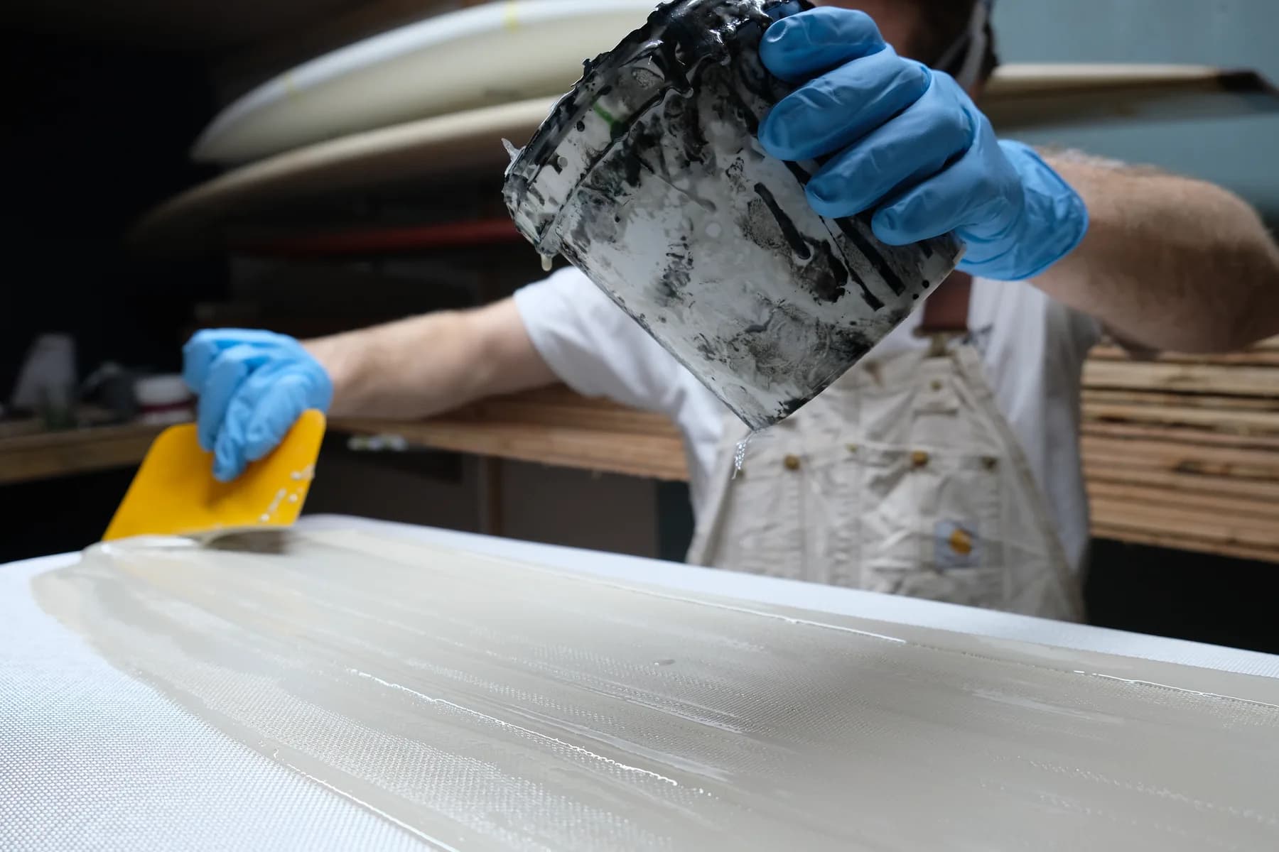 James working with surfboard materials in the Whitburn Studio workshop.