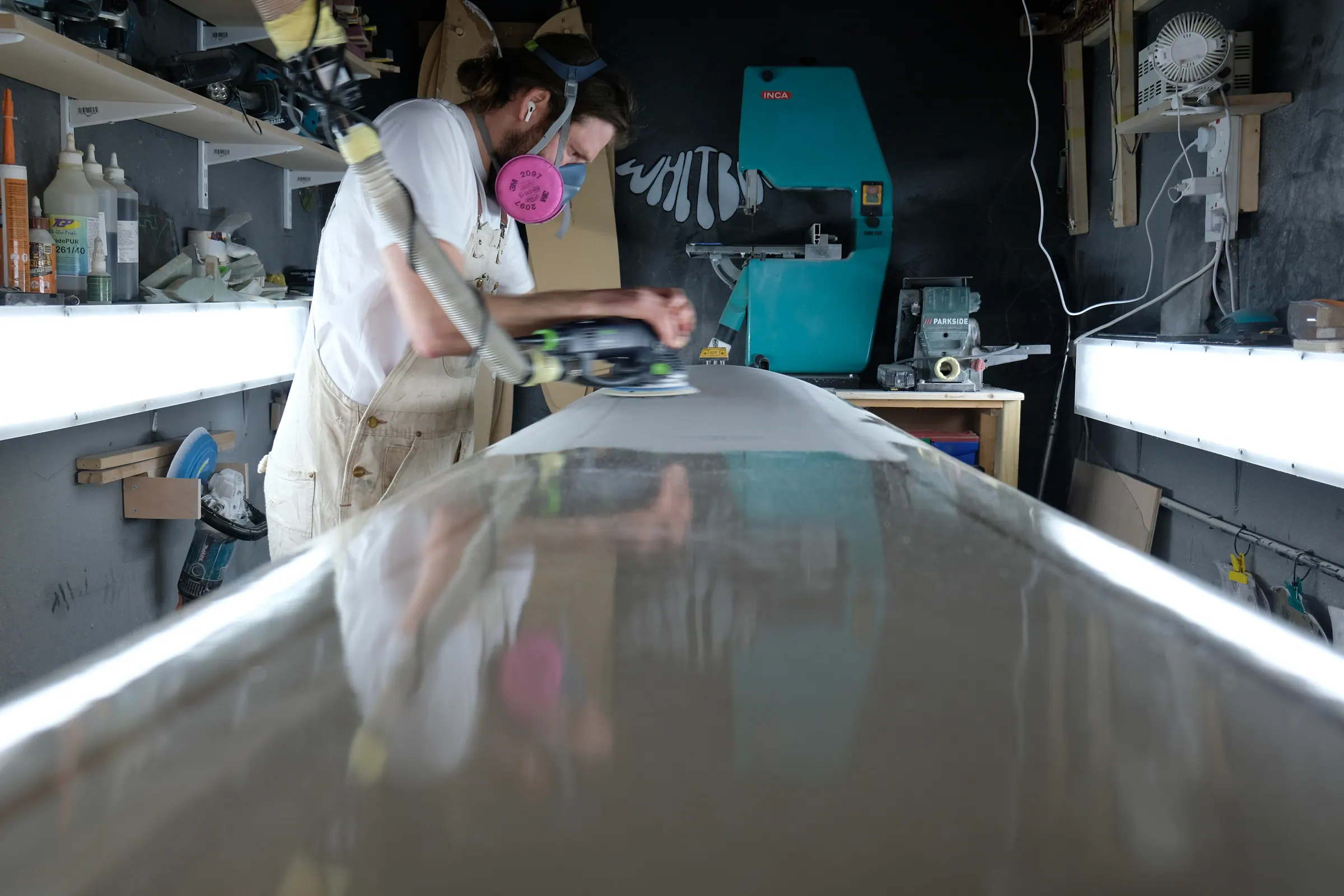 James Bailey working on a surfboard in the Whitburn Studio workshop.